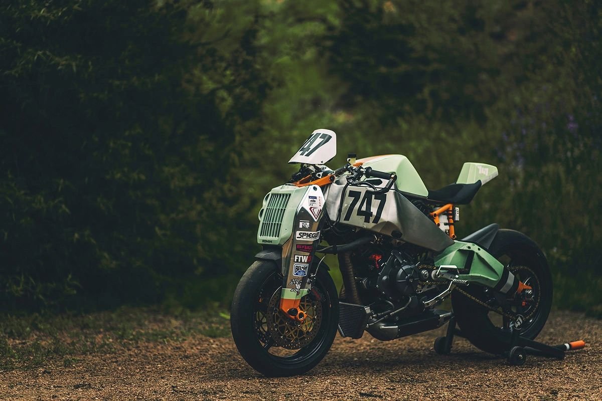 Mint and silver Magpul Ronin motorcycle parked in a forest